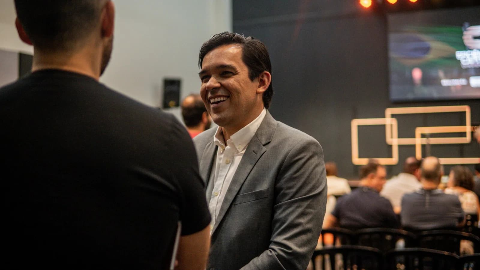 Gustavo, CEO da Sofe Capital, em conversa com participante durante evento de networking da Eficiência Capital Conference em Goiânia